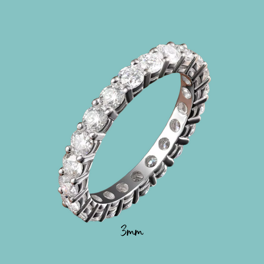 Silver ring with diamonds on a teal background