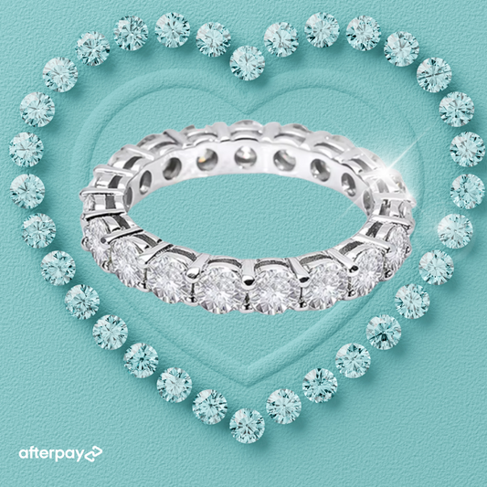 Silver ring with diamonds on a light blue background, featuring Afterpay logo.