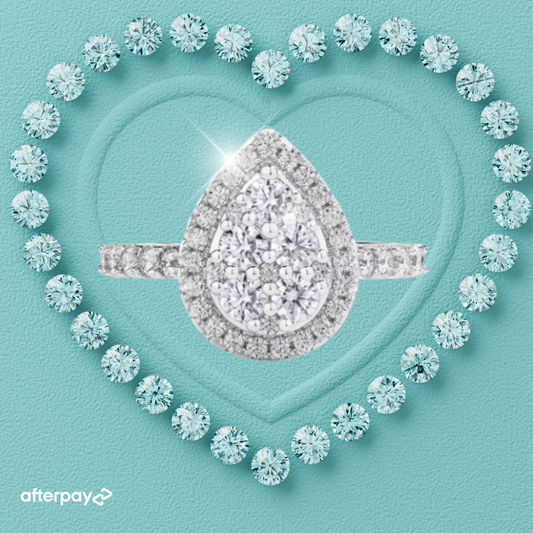 Pear shaped halo moissanite ring with pavé band in sterling silver