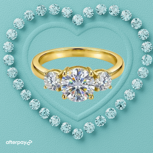 Round three stone moissanite ring with 1 carat centre stone available in gold or silver
