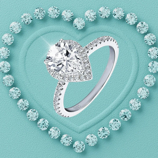 Pear cut moissanite halo ring with pavé band in sterling silver
