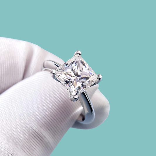 Princess cut moissanite solitaire ring with elegant knife edge band