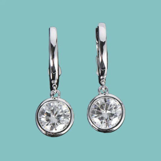 Round moissanite bezel drop earrings in sterling silver