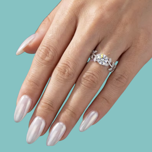 Silver botanical moissanite ring with brilliant round centre stone and twisting vine design