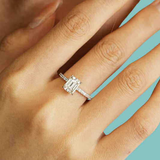 Emerald cut moissanite engagement ring with hidden halo detail
