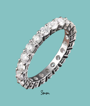 Silver ring with diamonds on a teal background