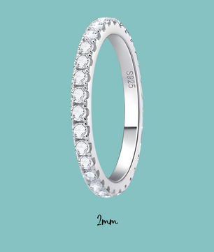 Silver ring with diamonds on a light blue background