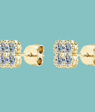 Gold square-cut stud earrings on a light blue background