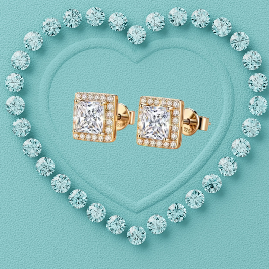 A pair of square yellow gold stud earrings with princess-cut clear center stones and a halo of smaller clear stones, arranged on a turquoise heart-shaped background surrounded by matching clear stones.