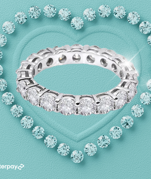 Silver ring with diamonds on a light blue background, featuring Afterpay logo.