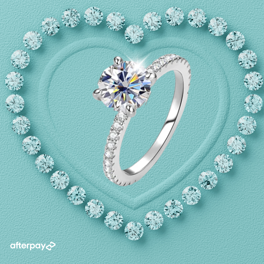 Juliette Hidden Halo Ring featuring a 1 carat round moissanite in a four-prong setting with pavé band and hidden halo detail.
