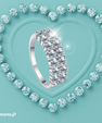 Celina wide pavé moissanite band with rows of sparkling round stones in a silver setting.