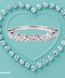 Everkiss moissanite band featuring round stones and polished X shaped detailing