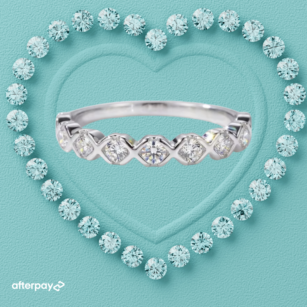 Everkiss moissanite band featuring round stones and polished X shaped detailing