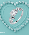 Nature inspired moissanite ring featuring a round centre stone and delicate pavé leaf details