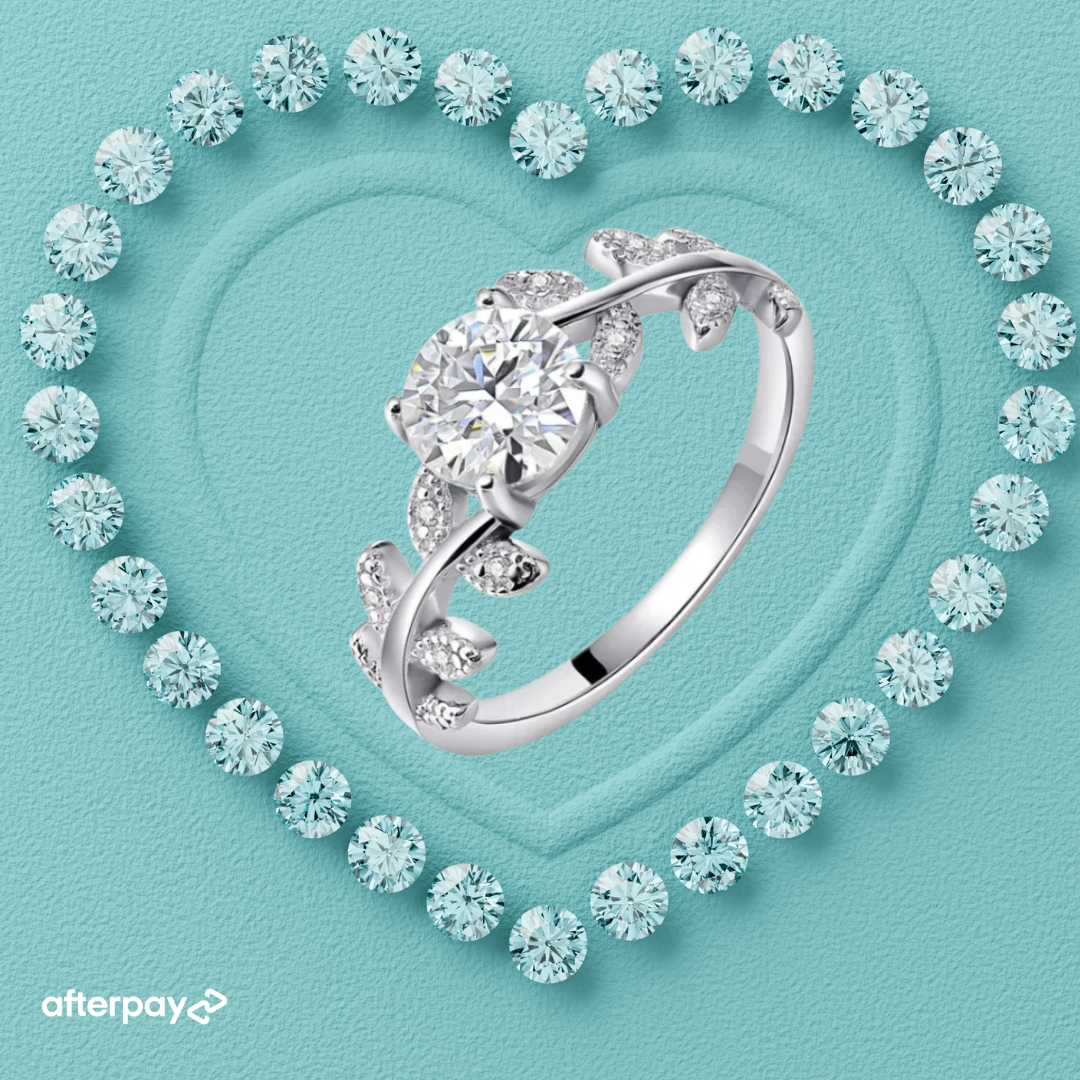Nature inspired moissanite ring featuring a round centre stone and delicate pavé leaf details