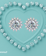 Camille round moissanite stud earrings with floral halo settings