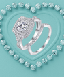 A silver-toned double ring set with pavé diamonds, featuring a square halo ring and a matching band, displayed on a textured turquoise background with a heart outline of round diamonds.