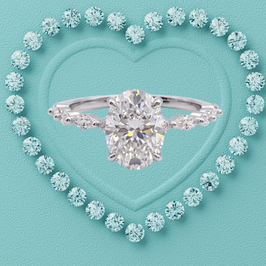 A silver engagement ring with a large oval center stone and marquise-cut side stones, centered on a turquoise heart-shaped background surrounded by small matching stones.