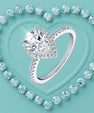 Pear cut moissanite halo ring with pavé band in sterling silver