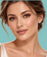 A close-up portrait of a woman wearing small round diamond stud earrings against a solid turquoise background.