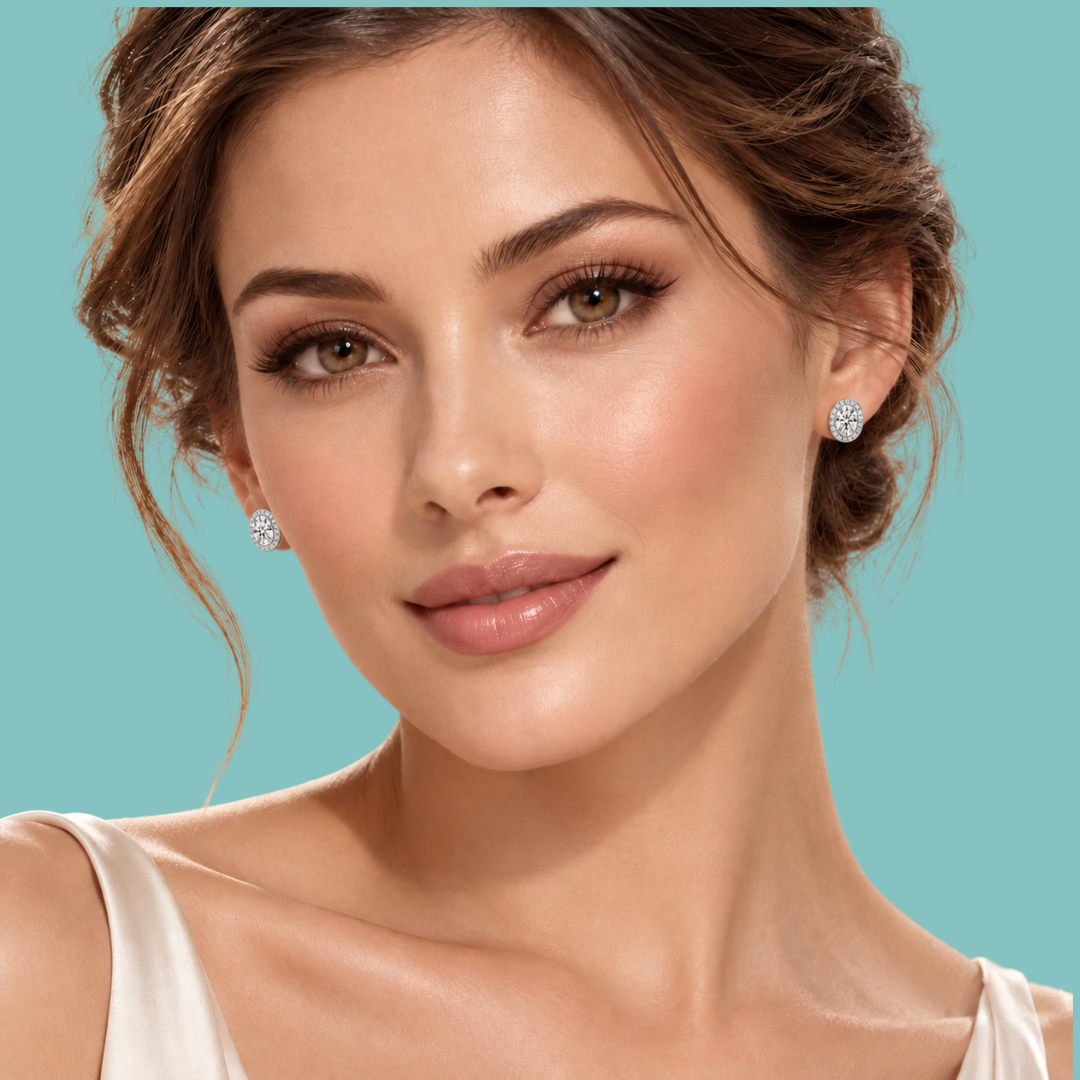 A close-up portrait of a woman wearing small round diamond stud earrings against a solid turquoise background.