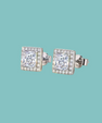 A pair of square stud earrings with princess-cut clear gemstones surrounded by a halo of smaller clear stones, set in silver-toned metal on a solid light teal background.