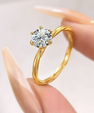 Round cut moissanite solitaire engagement ring in gold