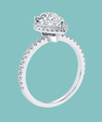 A silver-toned halo ring with a large oval center stone and small pavé accents along the band, shown on a solid light teal background.