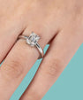 Dainty emerald cut solitaire ring with classic claw setting