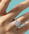 Pear shaped halo moissanite ring with pavé band in sterling silver