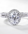 Oval halo bridal ring set with sparkling centre stone and matching band