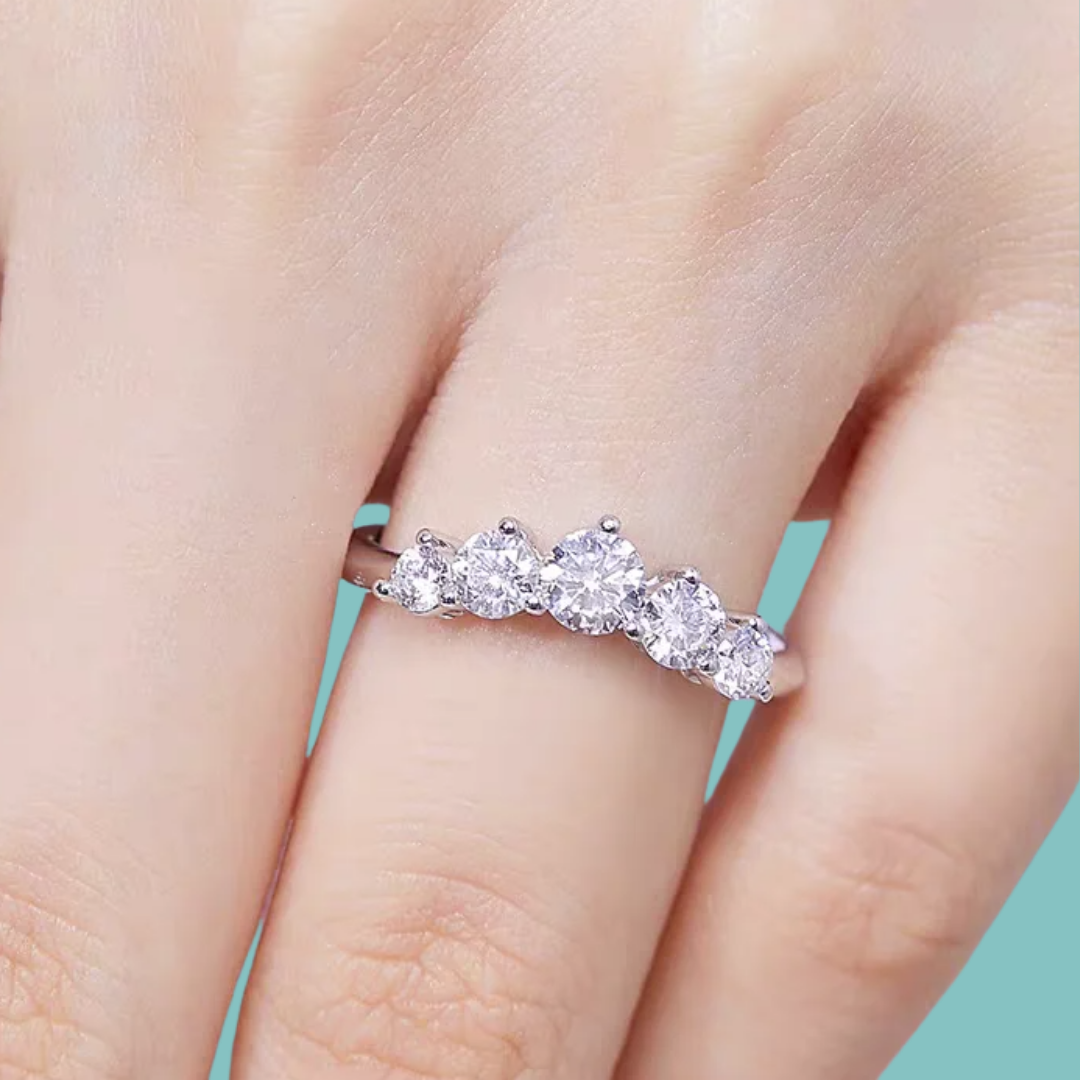 Modern contour ring with claw-set moissanite stones in a curved arc