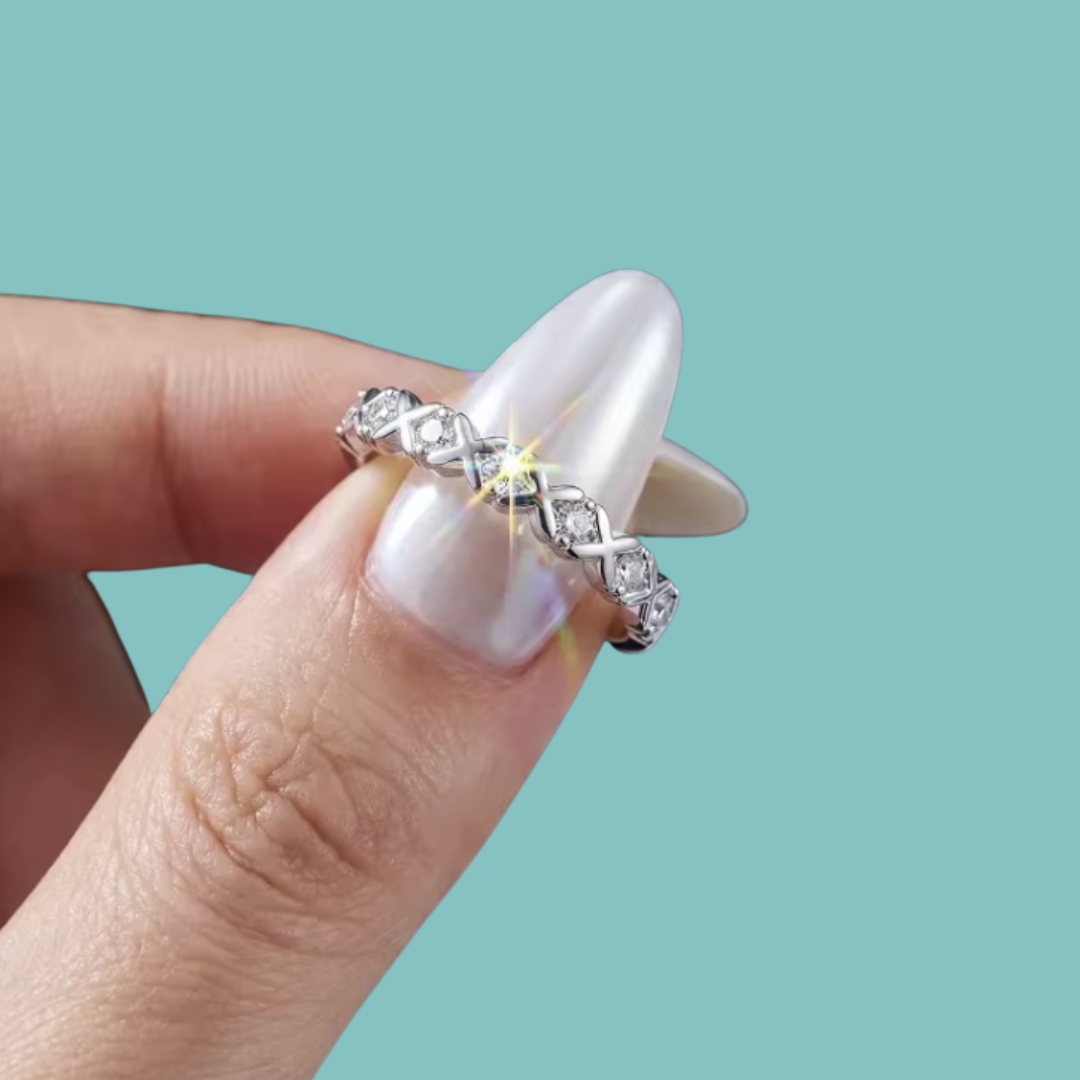 Delicate moissanite stacking band with sparkling round stones and repeating X design