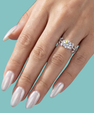 Silver botanical moissanite ring with brilliant round centre stone and twisting vine design