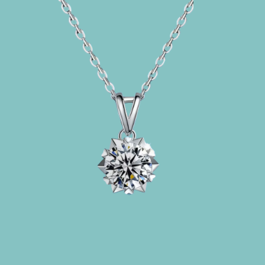 Brilliant round moissanite necklace with pointed starburst setting and V-shaped bail