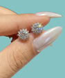 Silver-tone halo moissanite stud earrings displayed on a white background