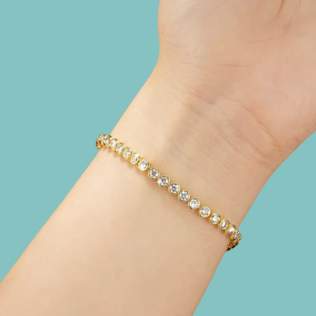Close-up of a sparkling bezel moissanite bracelet held between fingers