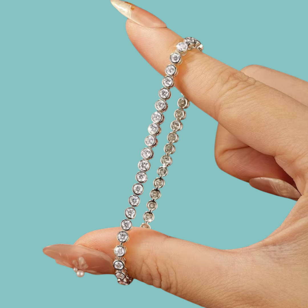 Close-up of a sparkling bezel moissanite bracelet held between fingers