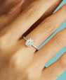 Emerald cut moissanite engagement ring with hidden halo detail