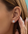 Round moissanite stud earrings in a warm gold-coloured setting, perfect for everyday sparkle.