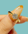 Round brilliant cut moissanite ring in sterling silver finish with classic solitaire setting.
