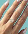 Oval cut moissanite ring with slim yellow solitaire band.
