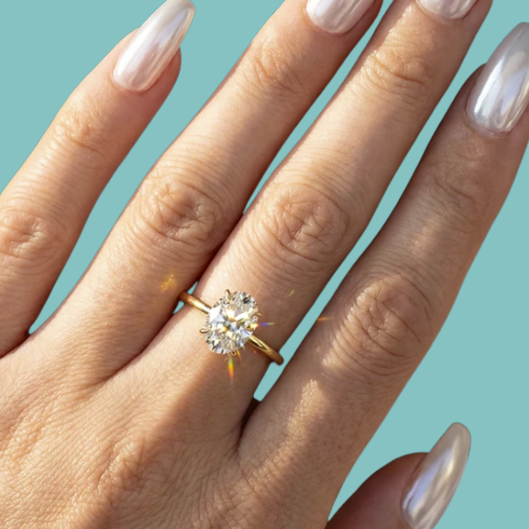 Oval cut moissanite ring with slim yellow solitaire band.