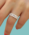 Statement moissanite band featuring multiple rows of round-cut stones on a silver band.