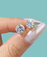 Classic gold-coloured moissanite stud earrings with brilliant round-cut 1 carat stones.