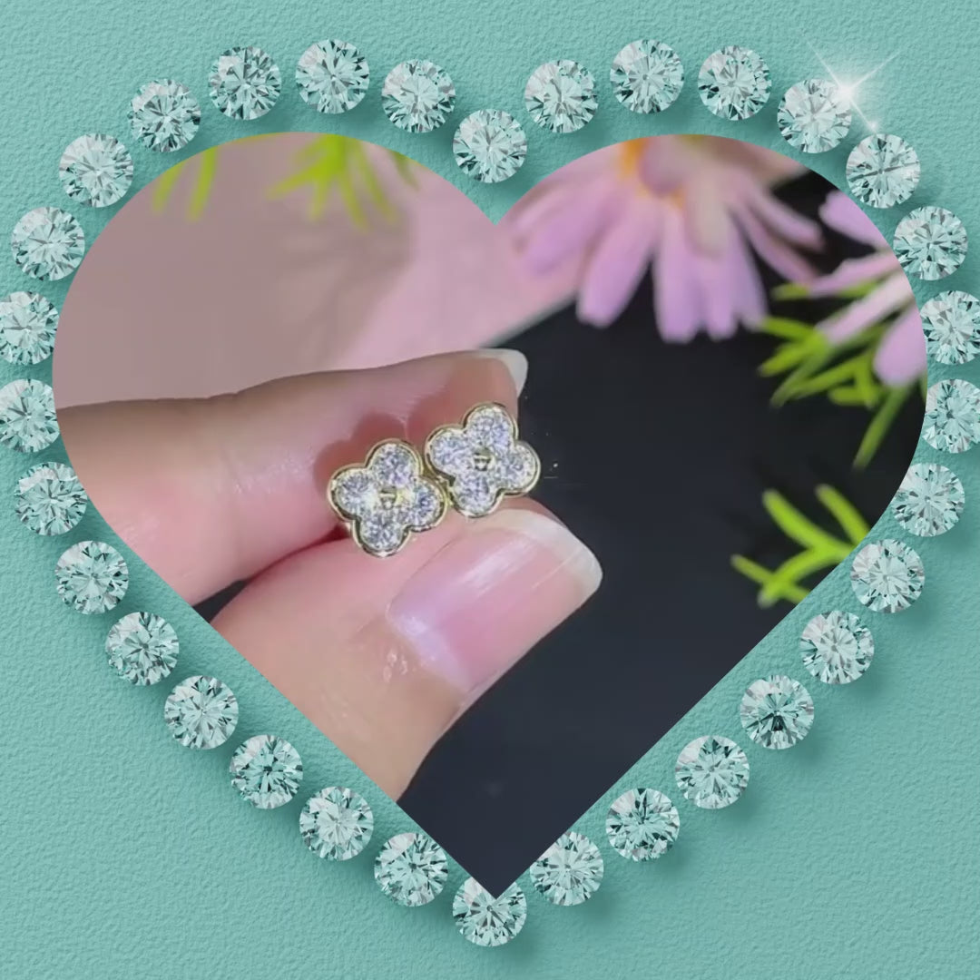 Close-up of sparkling four-petal moissanite flower stud earrings