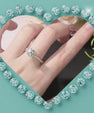 Elegant hidden halo moissanite ring featuring a 1 carat round brilliant stone and pavé band in 14K gold filled.