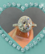Classic oval cut moissanite ring with halo and shimmering band