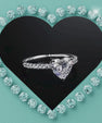 Heart shaped moissanite solitaire ring with pavé set band